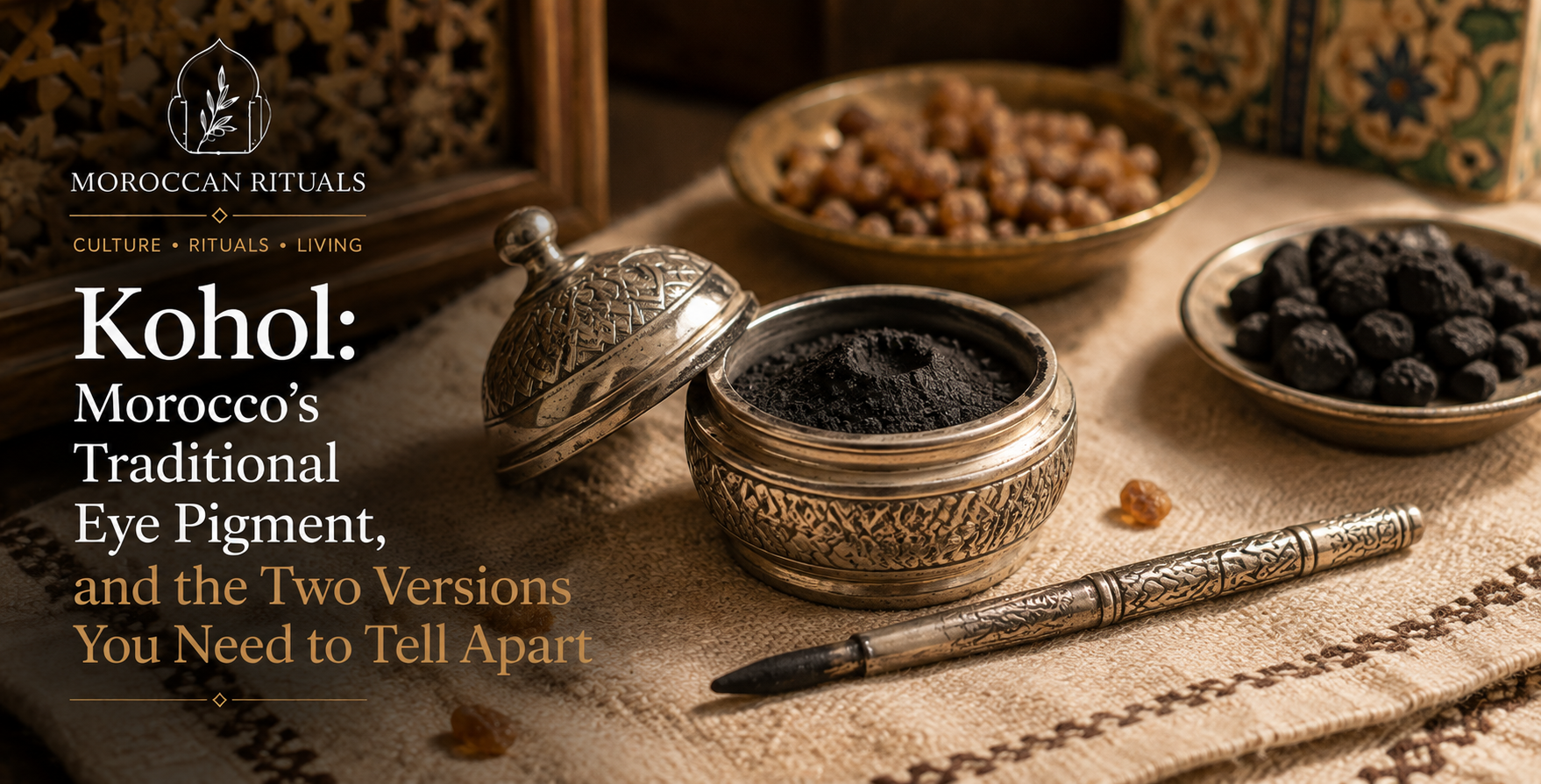 A traditional Moroccan mkahla — a small silver-etched pot with a matching kohl stick (mirwed) resting beside it — containing a finely ground kohol powder on a linen surface.